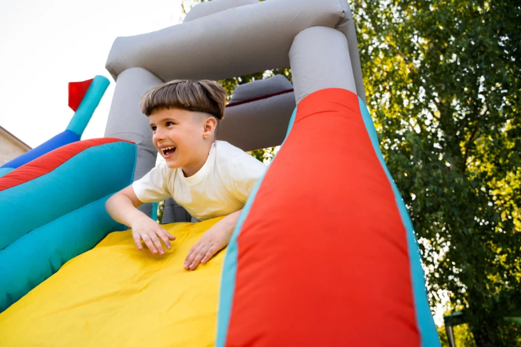 Inflatable obstacle course rental showing slides and climbing walls