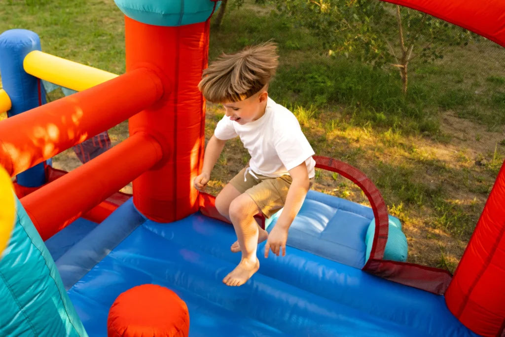 Inflatable bounce house set up outdoors with kids playing inside