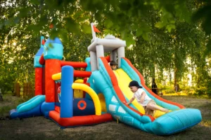 Toddlers jumping and laughing in a colorful mini bounce house indoors