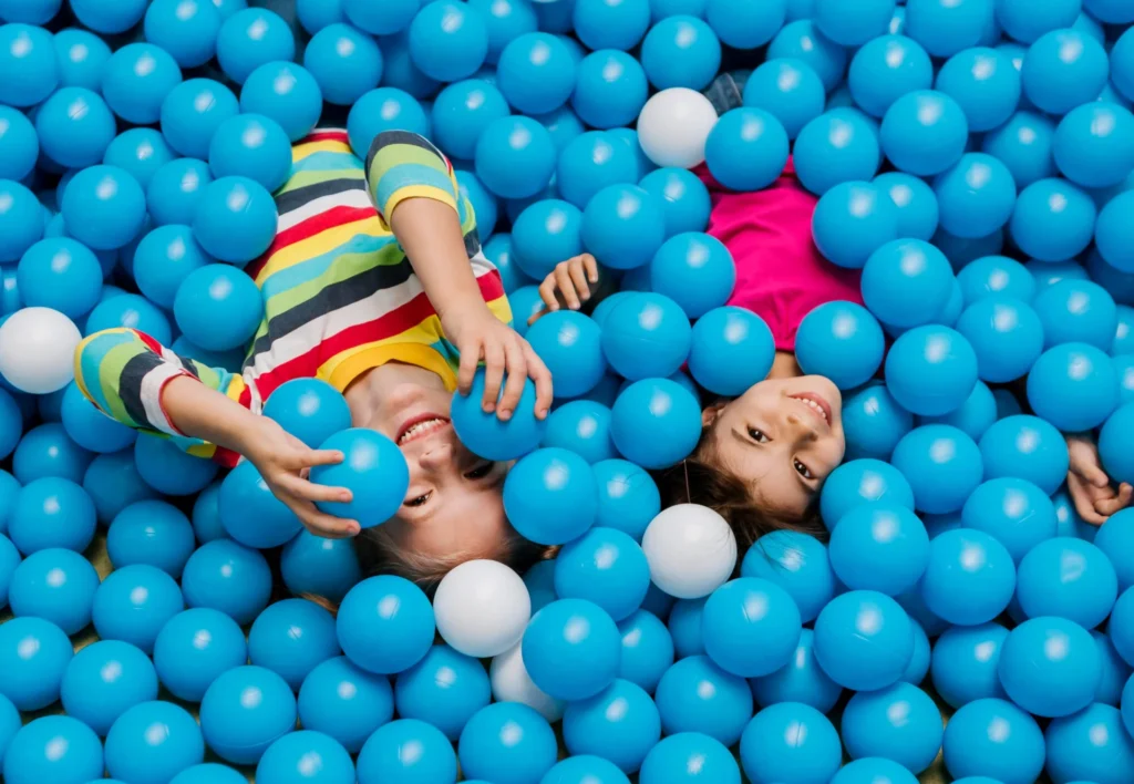 Kids playing inside a colorful bouncy castle at a birthday party rental