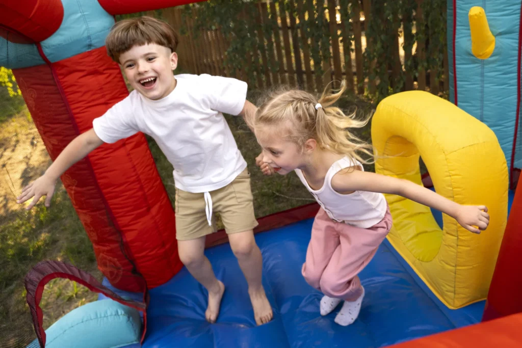 A colorful inflatable jumping castle set up in a backyard party
