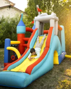 Kids playing in colorful bounce house rental at a backyard party