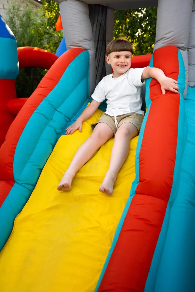 Kids enjoying a colorful jumping castle at a birthday party rental setup